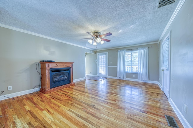 unfurnished living room featuring visible vents, ceiling fan, light wood-style floors, and a glass covered fireplace