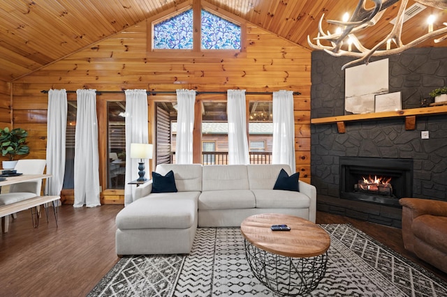 living room with wooden ceiling, wood-type flooring, a fireplace, and a wealth of natural light