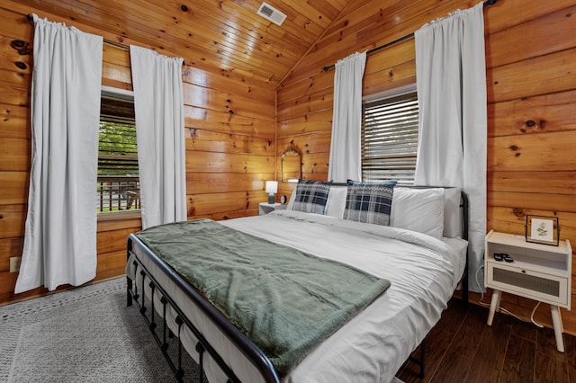 bedroom featuring lofted ceiling, dark wood-type flooring, wood ceiling, and wooden walls