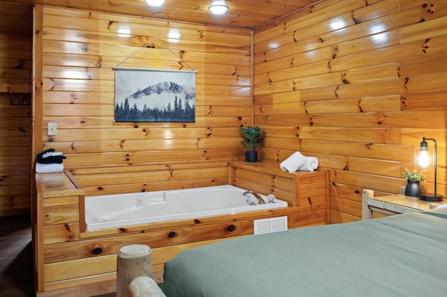 bathroom featuring wooden walls and a tub