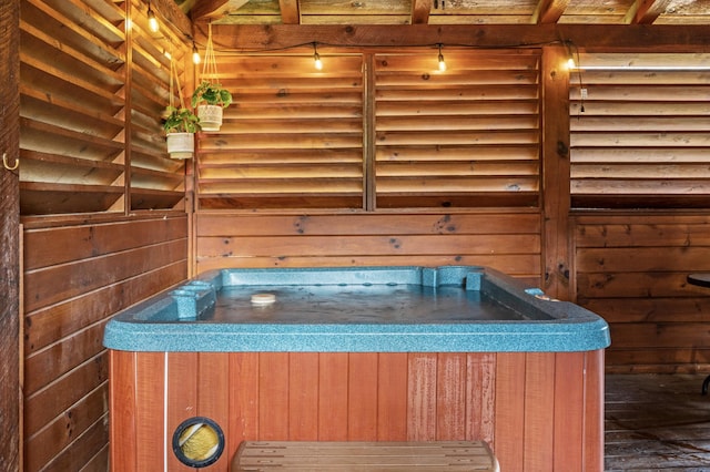 details with wooden walls and a hot tub