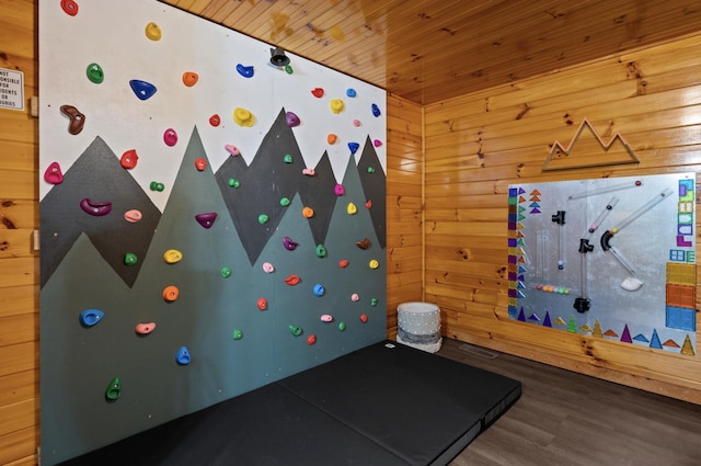 game room with hardwood / wood-style floors, wooden ceiling, and wood walls