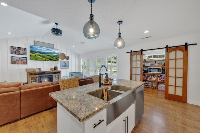 113 Cheshire Ct, Jefferson City, TN 37760 - kitchen featuring a barn door, pendant lighting, light wood-style floors, lofted ceiling, and open floor plan