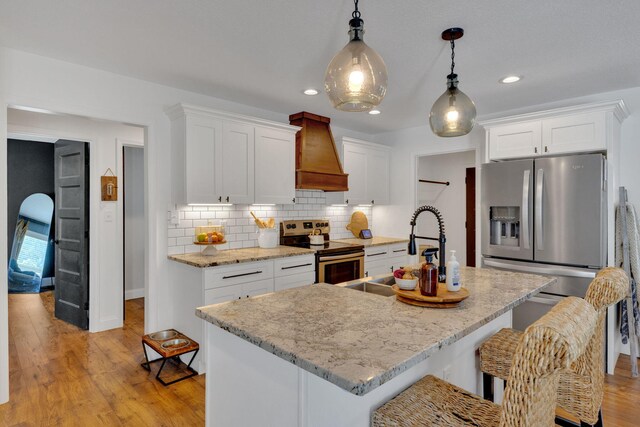 113 Cheshire Ct, Jefferson City, TN 37760 - kitchen with stainless steel appliances, custom exhaust hood, light wood-style floors, recessed lighting, and white cabinets