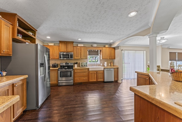 104-116 Circle Rd, Newport, TN 37821 - kitchen featuring appliances with stainless steel finishes, decorative columns, healthy amount of natural light, dark wood finished floors, and crown molding