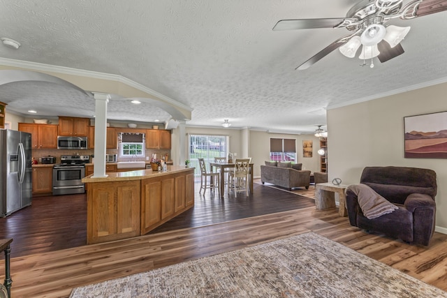 104-116 Circle Rd, Newport, TN 37821 - kitchen featuring appliances with stainless steel finishes, open floor plan, a ceiling fan, decorative columns, and ornamental molding