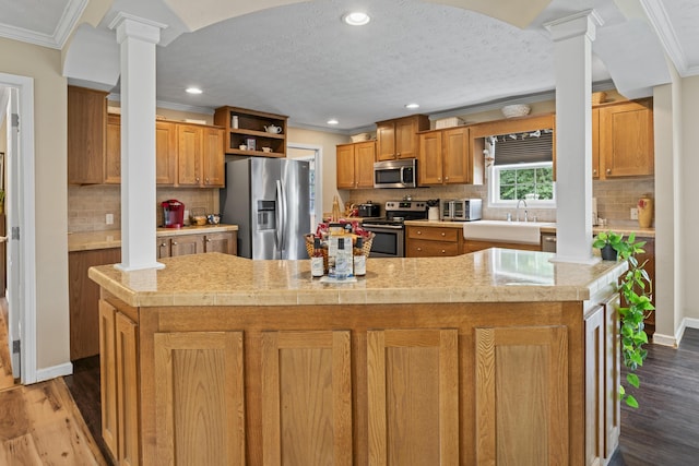 104-116 Circle Rd, Newport, TN 37821 - kitchen with appliances with stainless steel finishes, ornate columns, crown molding, light countertops, and backsplash