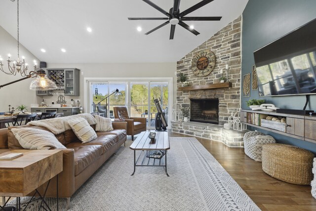 340 Back Nine Dr, Baneberry, TN 37890 - living room with high vaulted ceiling, wood finished floors, ceiling fan, a chandelier, and a stone fireplace