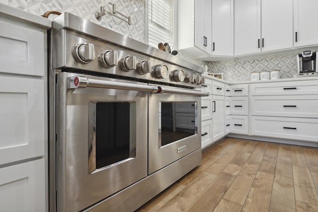 340 Back Nine Dr, Baneberry, TN 37890 - kitchen featuring range with two ovens, white cabinets, decorative backsplash, and light wood-type flooring