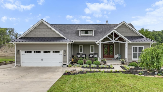 340 Back Nine Dr, Baneberry, TN 37890 - craftsman-style home featuring a standing seam roof, a porch, a front lawn, concrete driveway, and a garage