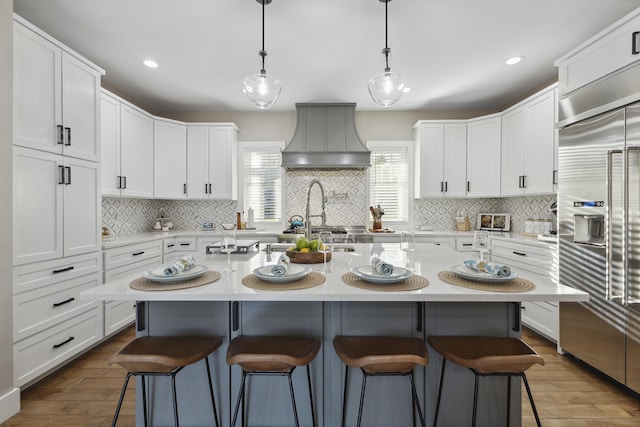 340 Back Nine Dr, Baneberry, TN 37890 - kitchen with built in fridge, premium range hood, a kitchen breakfast bar, light countertops, and white cabinets