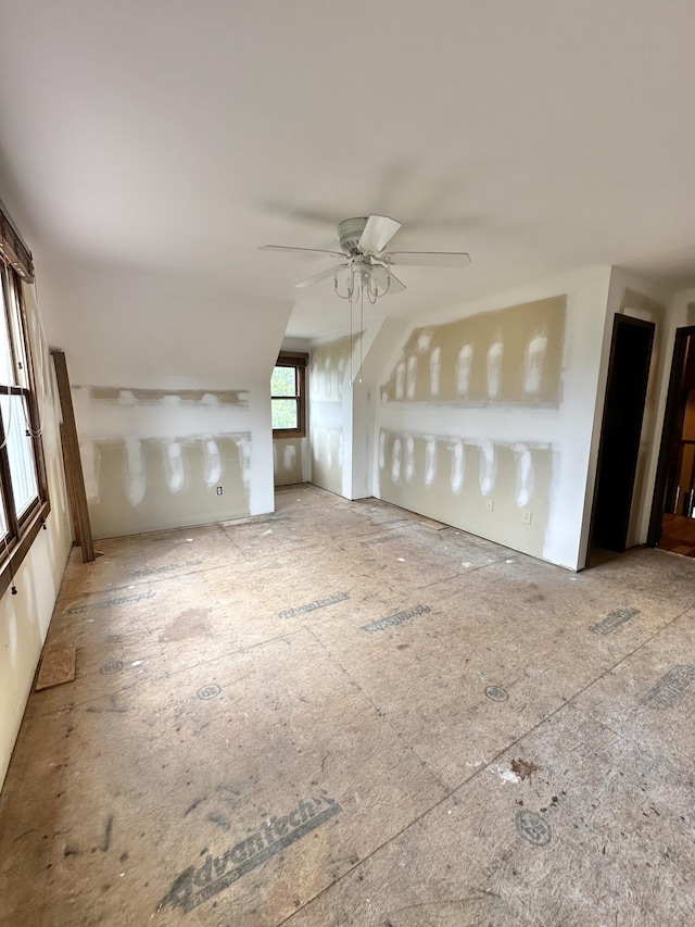 unfurnished living room with ceiling fan