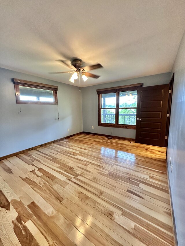 unfurnished room featuring light hardwood / wood-style flooring and ceiling fan