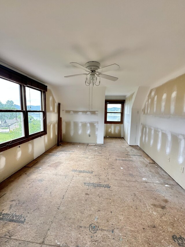 unfurnished living room featuring ceiling fan