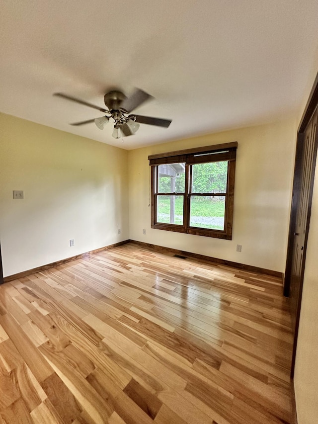 unfurnished room with ceiling fan and light hardwood / wood-style flooring