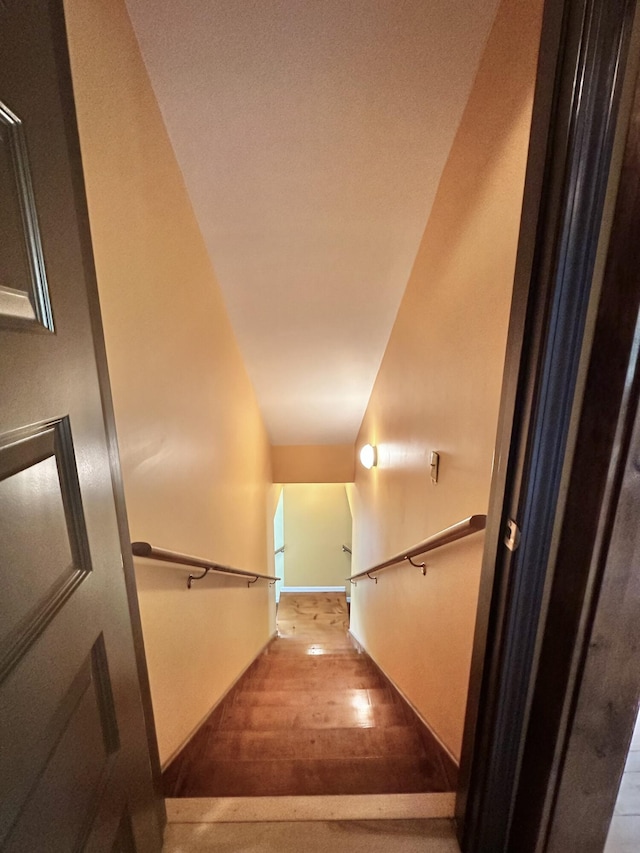 stairs featuring hardwood / wood-style floors