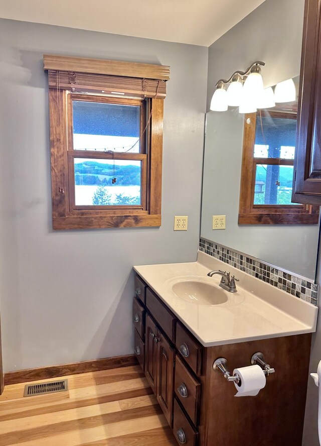 bathroom featuring hardwood / wood-style floors, vanity, and toilet