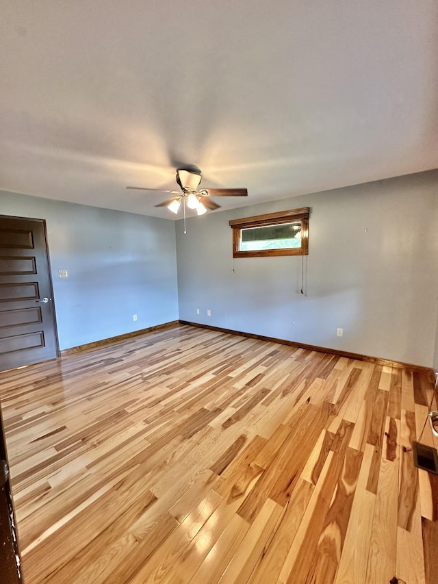 spare room featuring ceiling fan and light hardwood / wood-style flooring