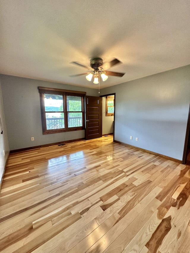 spare room featuring ceiling fan and light wood-type flooring