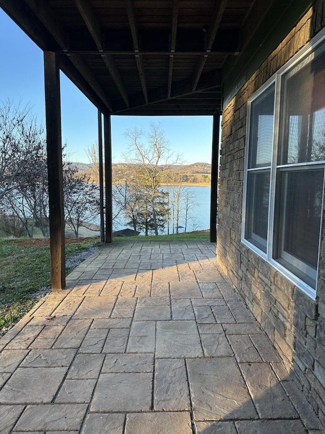 view of patio featuring a water view