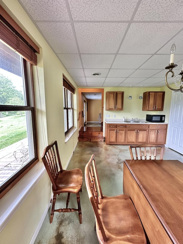 dining room with a drop ceiling and sink