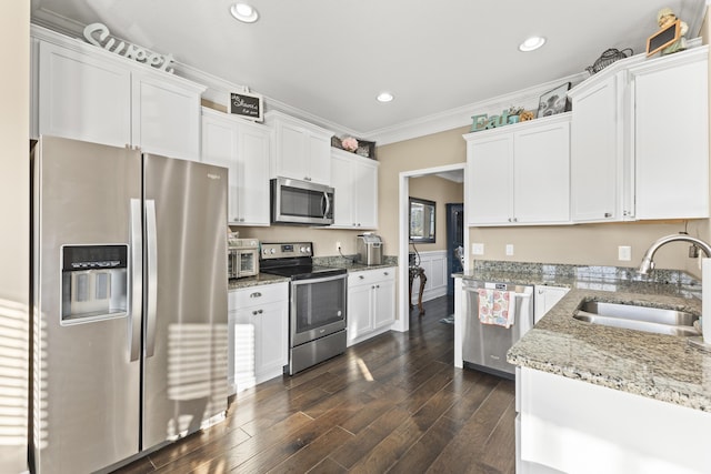 9357 Gabrielle Rd, Strawberry Plains, TN 37871 - kitchen with appliances with stainless steel finishes, a sink, white cabinetry, ornamental molding, and light stone countertops
