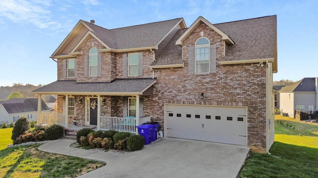 9357 Gabrielle Rd, Strawberry Plains, TN 37871 - view of front of property with a porch, brick siding, driveway, a shingled roof, and an attached garage