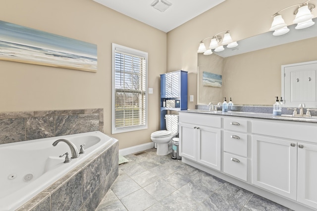 9357 Gabrielle Rd, Strawberry Plains, TN 37871 - full bath with toilet, double vanity, a tub with jets, and baseboards