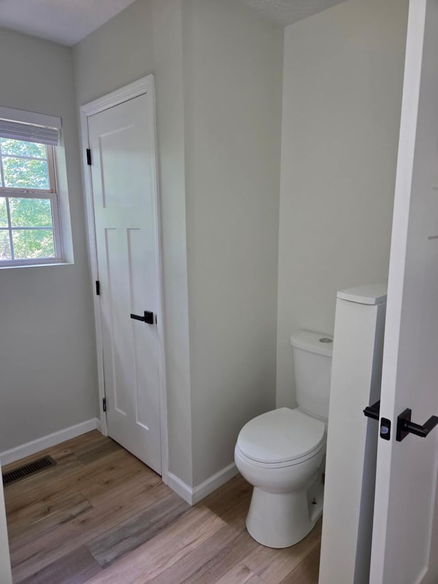 1705 Lester Rd, Tazewell, TN 37879 - bathroom featuring wood finished floors, toilet, and baseboards