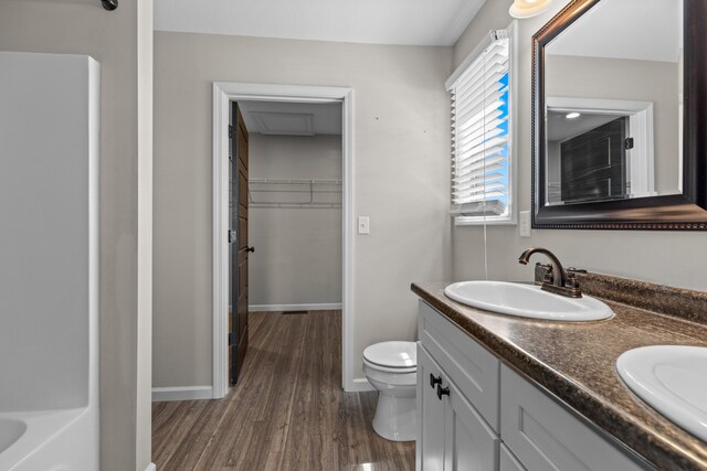 6625 Lainey Jane Ct, Whitesburg, TN 37891 - bathroom featuring wood finished floors, double vanity, toilet, and baseboards