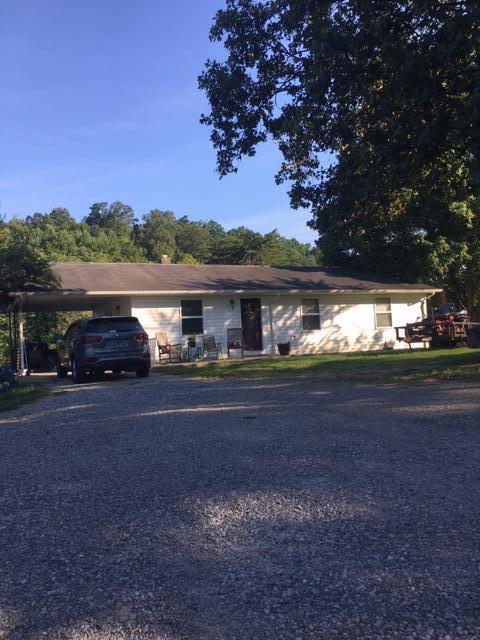 single story home featuring a carport