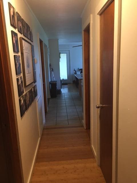 corridor with hardwood / wood-style flooring