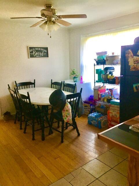 dining area with hardwood / wood-style floors and ceiling fan