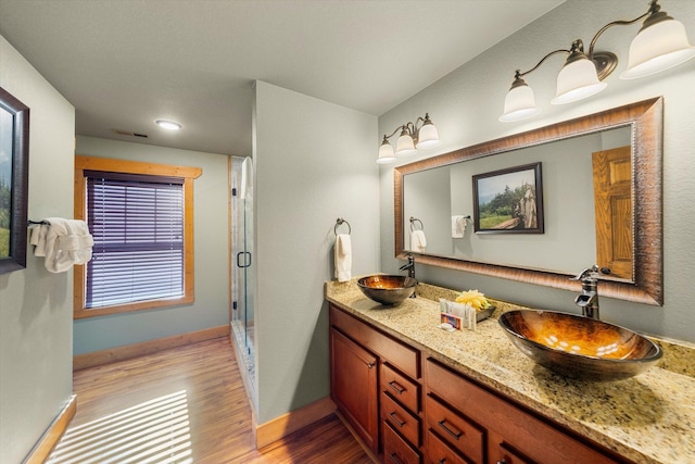 bathroom with vanity, hardwood / wood-style floors, and a shower with shower door