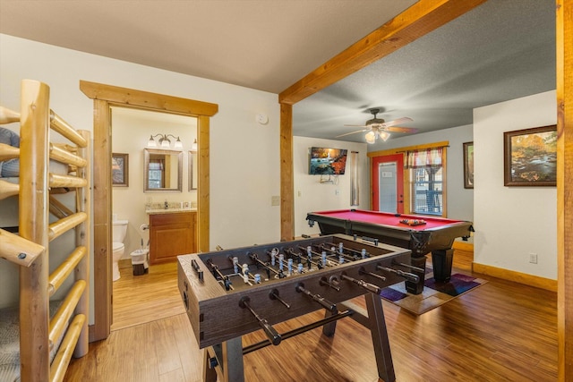 rec room featuring ceiling fan, billiards, light hardwood / wood-style floors, and a textured ceiling