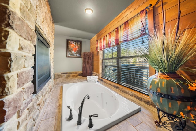 bathroom with a relaxing tiled tub and vaulted ceiling