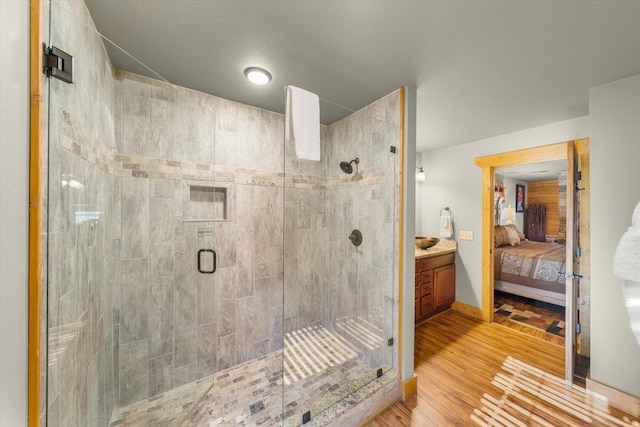 bathroom with vanity, wood-type flooring, and walk in shower