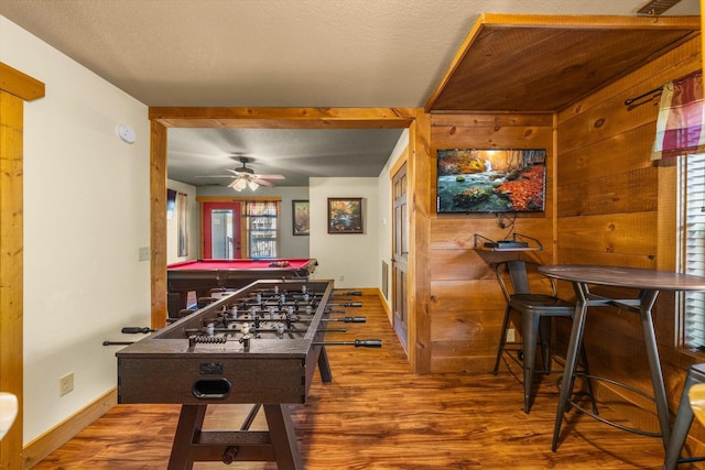 rec room with hardwood / wood-style flooring, pool table, and wood walls