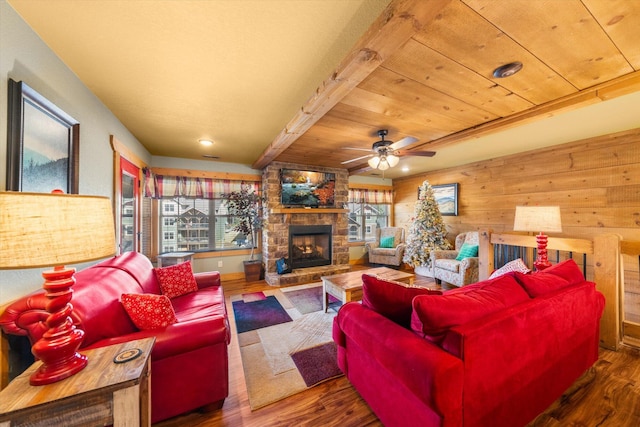 living room with a stone fireplace, wooden ceiling, dark hardwood / wood-style flooring, and wood walls