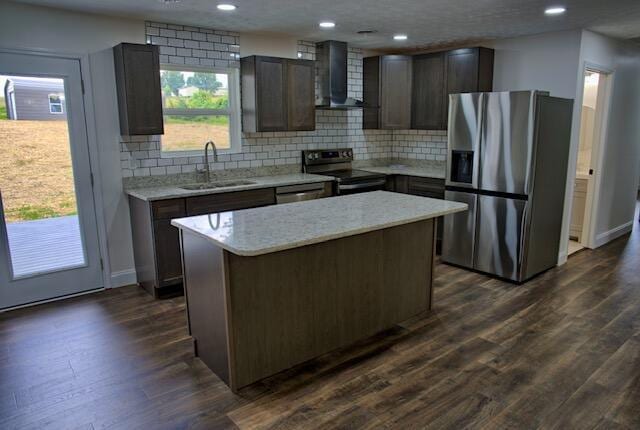 3646 Falcon Rd, Morristown, TN 37814 - kitchen featuring appliances with stainless steel finishes, wall chimney range hood, decorative backsplash, a kitchen island, and recessed lighting