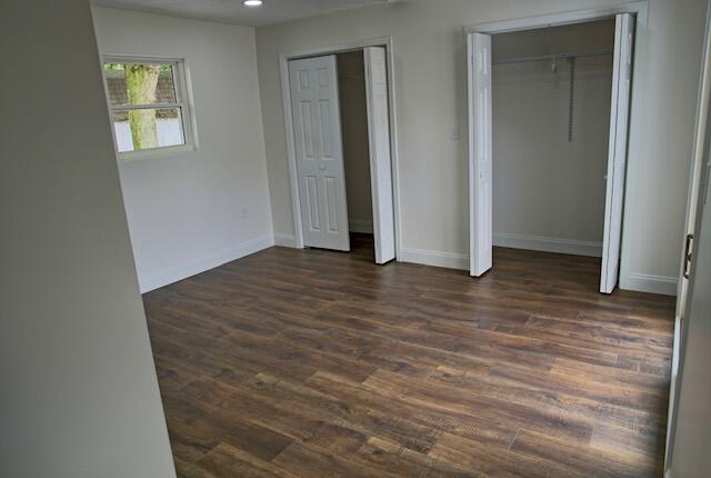 3646 Falcon Rd, Morristown, TN 37814 - unfurnished bedroom with two closets and dark wood-style floors
