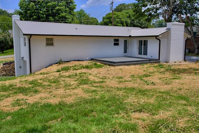 3646 Falcon Rd, Morristown, TN 37814 - rear view of house with a chimney, a yard, and a metal roof