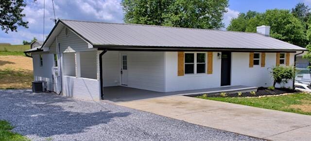 3646 Falcon Rd, Morristown, TN 37814 - view of front of home with driveway, a carport, a chimney, and a metal roof