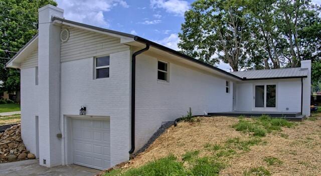 3646 Falcon Rd, Morristown, TN 37814 - view of side of property featuring a chimney, a garage, and concrete driveway