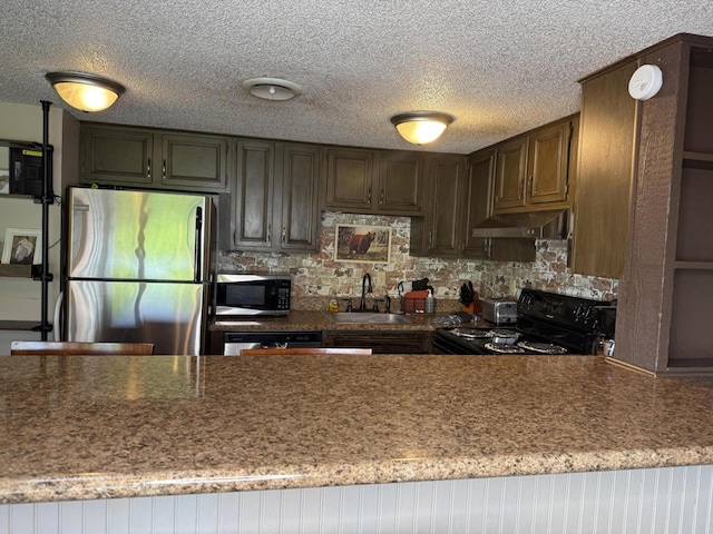 1081 Cove Rd Unit 734, Sevierville, TN 37876 - kitchen with appliances with stainless steel finishes, a sink, under cabinet range hood, tasteful backsplash, and a textured ceiling