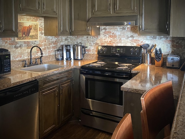 1081 Cove Rd Unit 734, Sevierville, TN 37876 - kitchen with appliances with stainless steel finishes, ventilation hood, a sink, and decorative backsplash