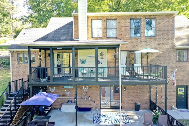 rear view of property with a patio area and a balcony