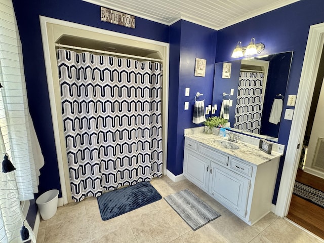 bathroom featuring tile patterned floors, vanity, and ornamental molding