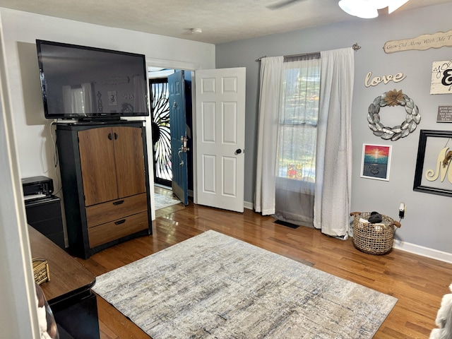 bedroom featuring hardwood / wood-style floors and ceiling fan