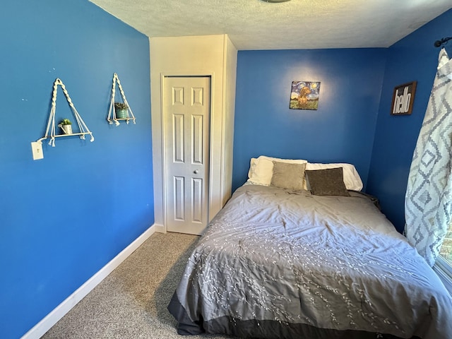 carpeted bedroom featuring a closet and a textured ceiling